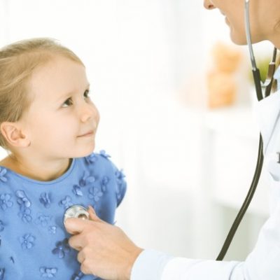 Doctor seeing girl patient.