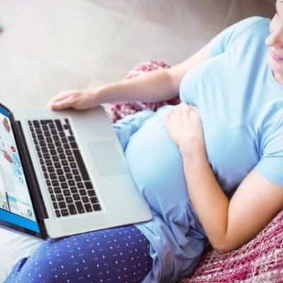 Pregnant woman using a laptop.