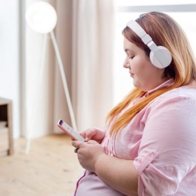 Woman with obesity using a smartphone.