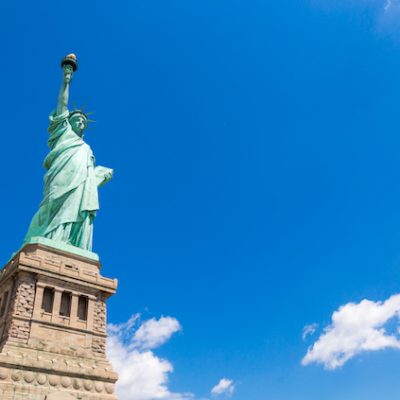 Statue of Liberty in New York City, USA with blue sky background