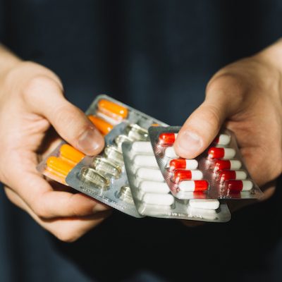 Hands holding pills