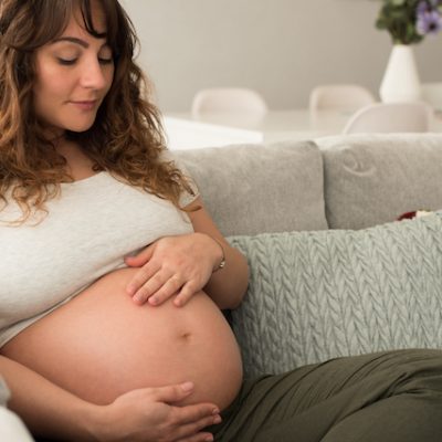 Pregnant woman touching her belly