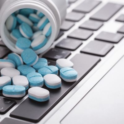 Pills on a laptop.
