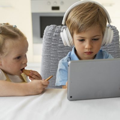 Children using a tablet computer at home.