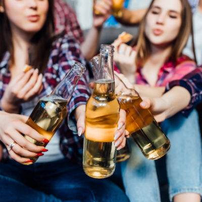 Group of girls cheering with beers