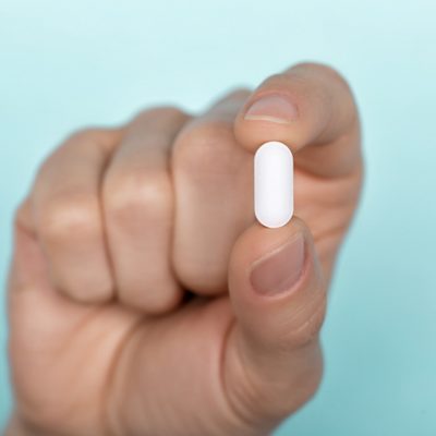 Pill in man's hand