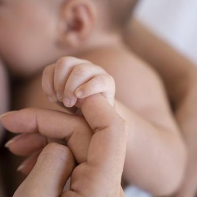 Baby breastfeeding with mother.