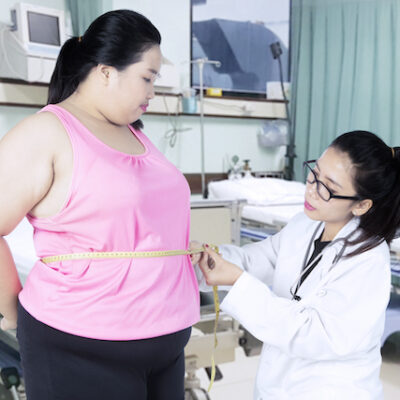 Doctor assisting patient with obesity.