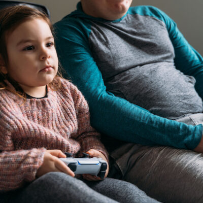 Father and child playing video games.