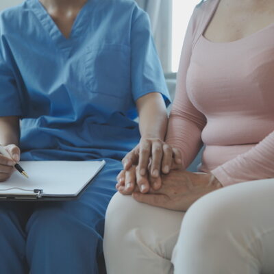 Patient with nurse in a hospital setting.