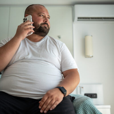 Man on the phone on his bed.
