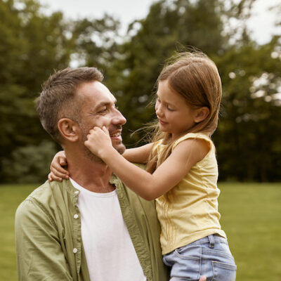 Father and daughter on a field.
