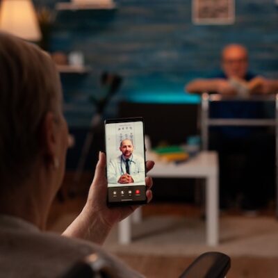 Elder woman using video call for telemedicine.