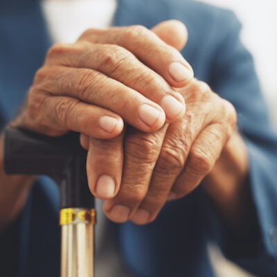 Elderly man with a walking stick.
