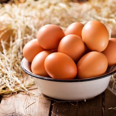 A bowl of eggs on a table.