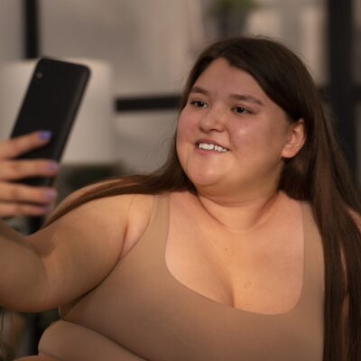 Woman with obesity speaking on her smartphone.