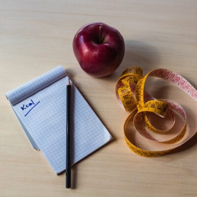 Diet plan, apple and measure tape.