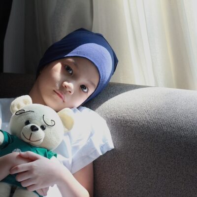 Child patient with cancer on a sofa.