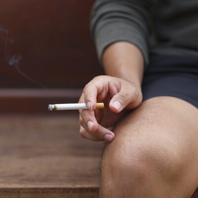 Man sitting and smoking a cigarette.