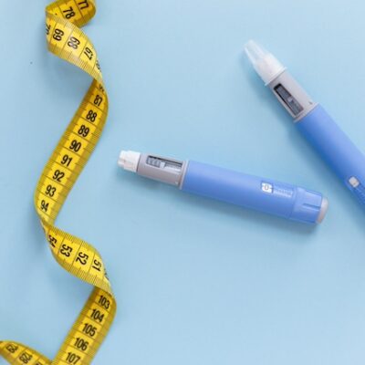 Obesity medication pens and a tape measure.