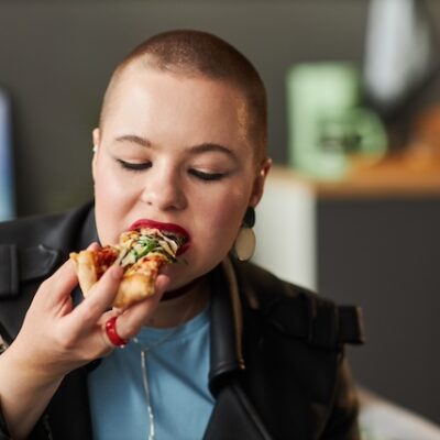 Teenage girl enjoying pizza