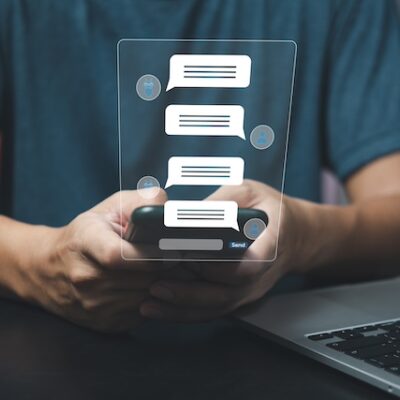 Healthcare professional using a smartphone to send messages.