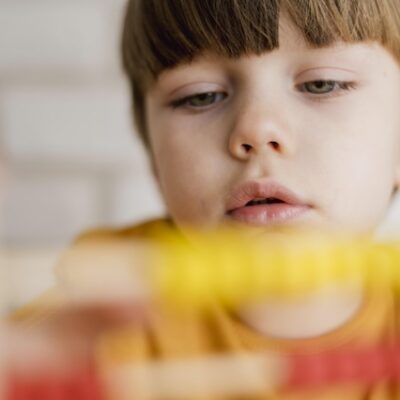 Closeup of a child using an abacus.