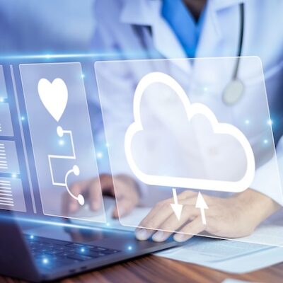 Doctor using computer with database and cloud software.