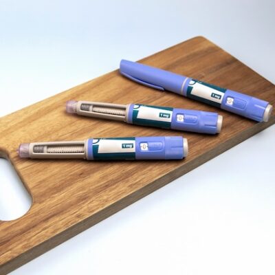 Ozempic pens on a chopping board.