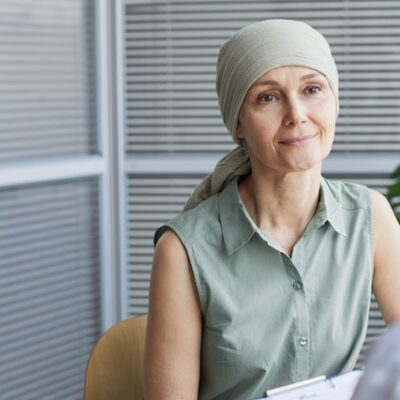 Adult woman with cancer visiting doctor.
