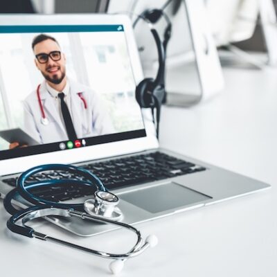 Doctor being consulted over telehealth technology.