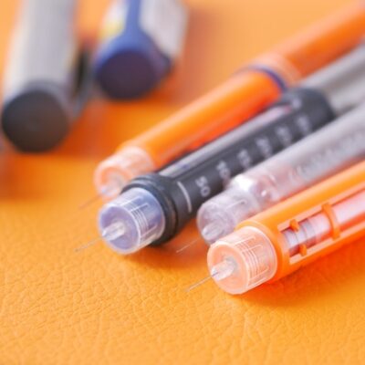 GLP-1 and insulin pens on a table.