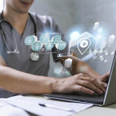 Health professional using generative AI on a laptop.