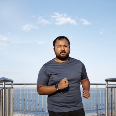 Man exercising by a lake.