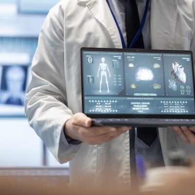 Physician presenting information on a computer.