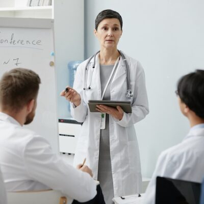 Senior female doctor presenting to audience.