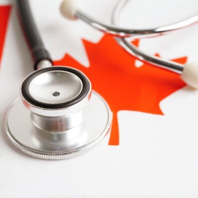 Stethoscope over a Canadian flag.