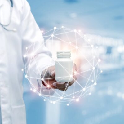 Doctor with stethoscope holding a white medicine bottle with data digital network hologram.