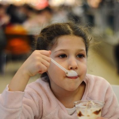 Close up of a girl eating lunch.