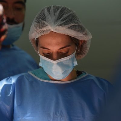 Woman surgeon wearing surgical outfit.