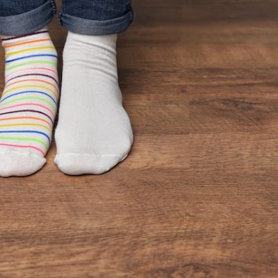 Child in different socks indoors.