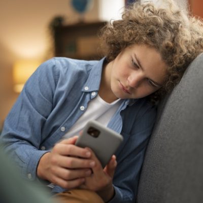 Young man looking at his smartphone.