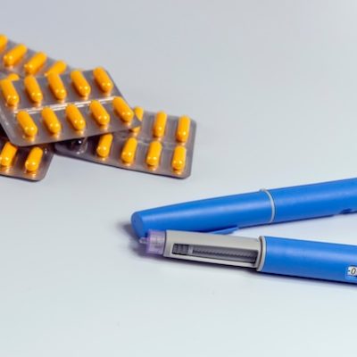 Ozempic pens and pills on a table.