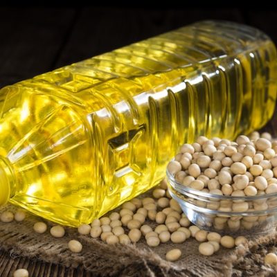 Bowl of soybeans and a bottle of soybean oil.