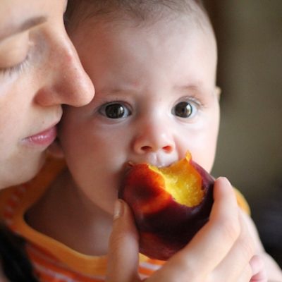 Mother and baby eating together.