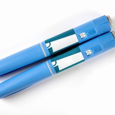 Two Ozempic pens on a white background.
