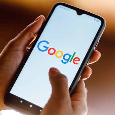 Person accessing a Google application on a smartphone.