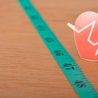 Heartbeat rate symbol and measuring tape.