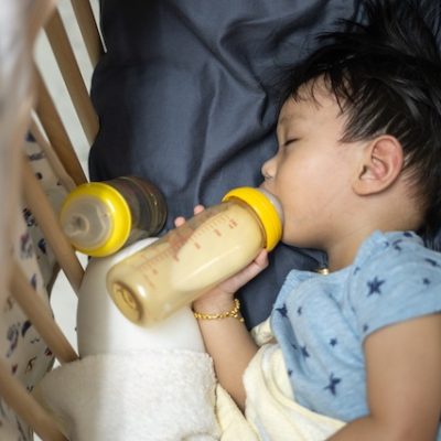 Toddler going to sleep with a bottle in his mouth.