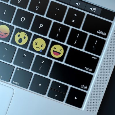 Emojis on a laptop keyboard.